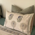 Decorative pillow with floral patterns on a bed
