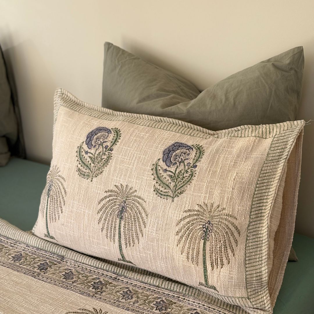 Decorative pillow with floral patterns on a bed